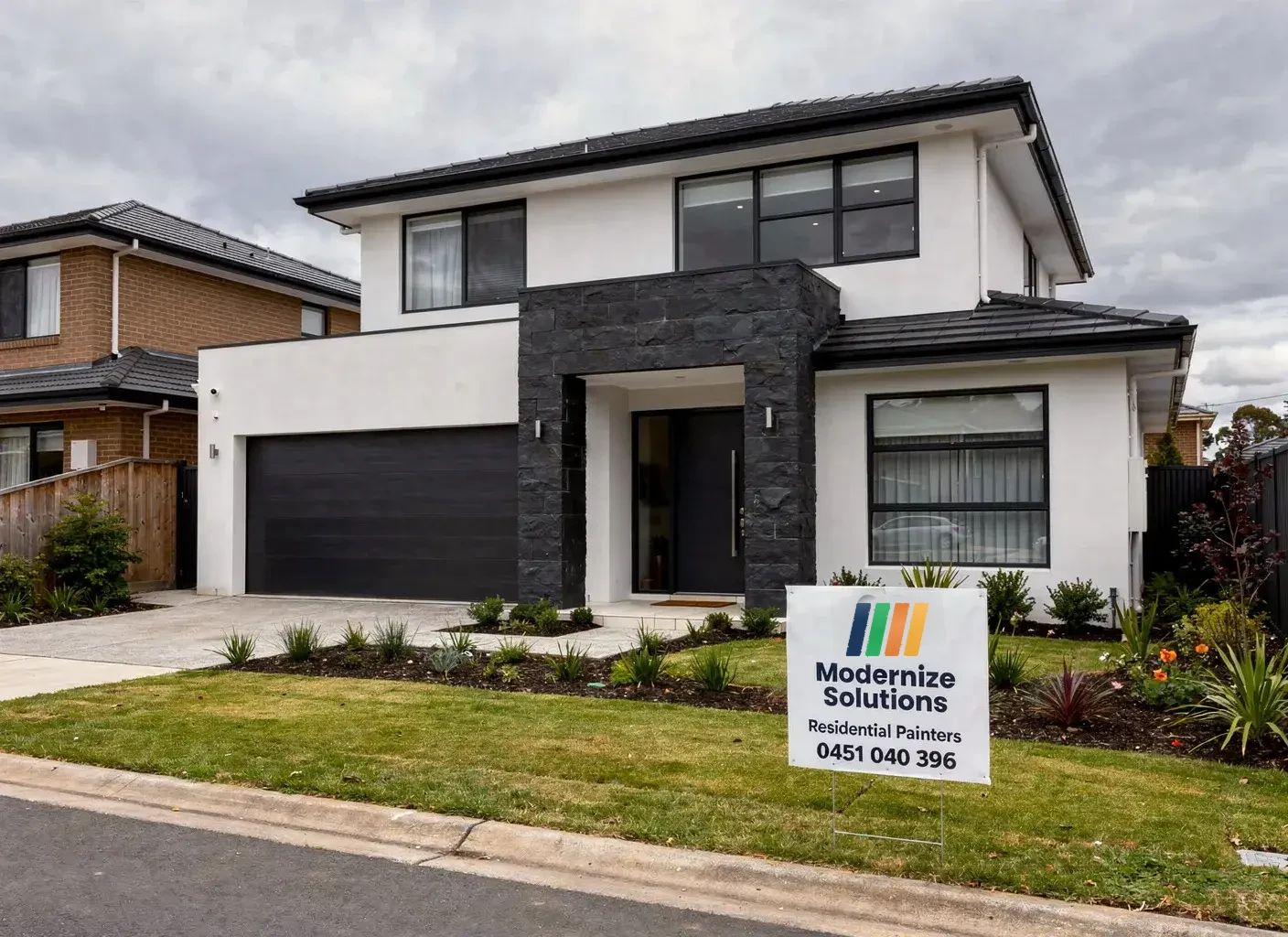 Modernize Solutions sign board in front of a newly painted two-storey Melbourne home