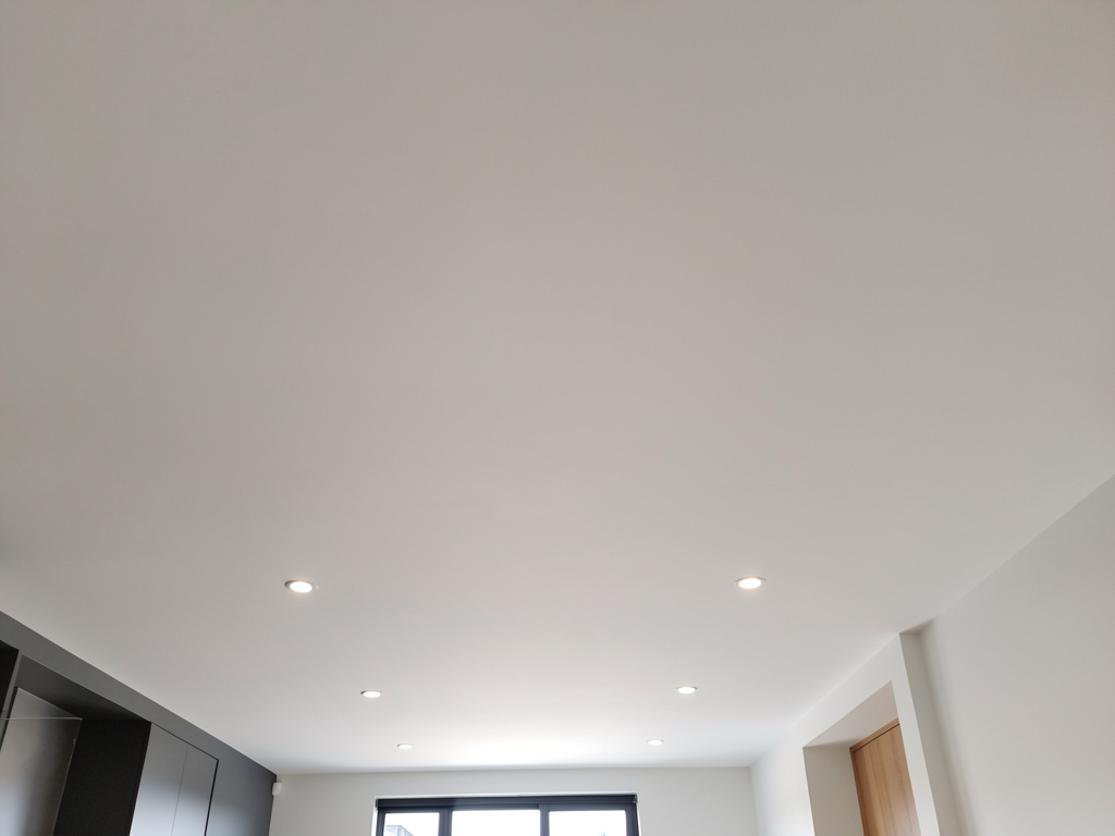 Smooth white ceiling painting with recessed downlights showing professional quality finish