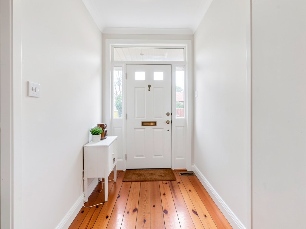 Freshly painted heritage entry foyer in a Hoppers Crossing home with white walls and timber floors