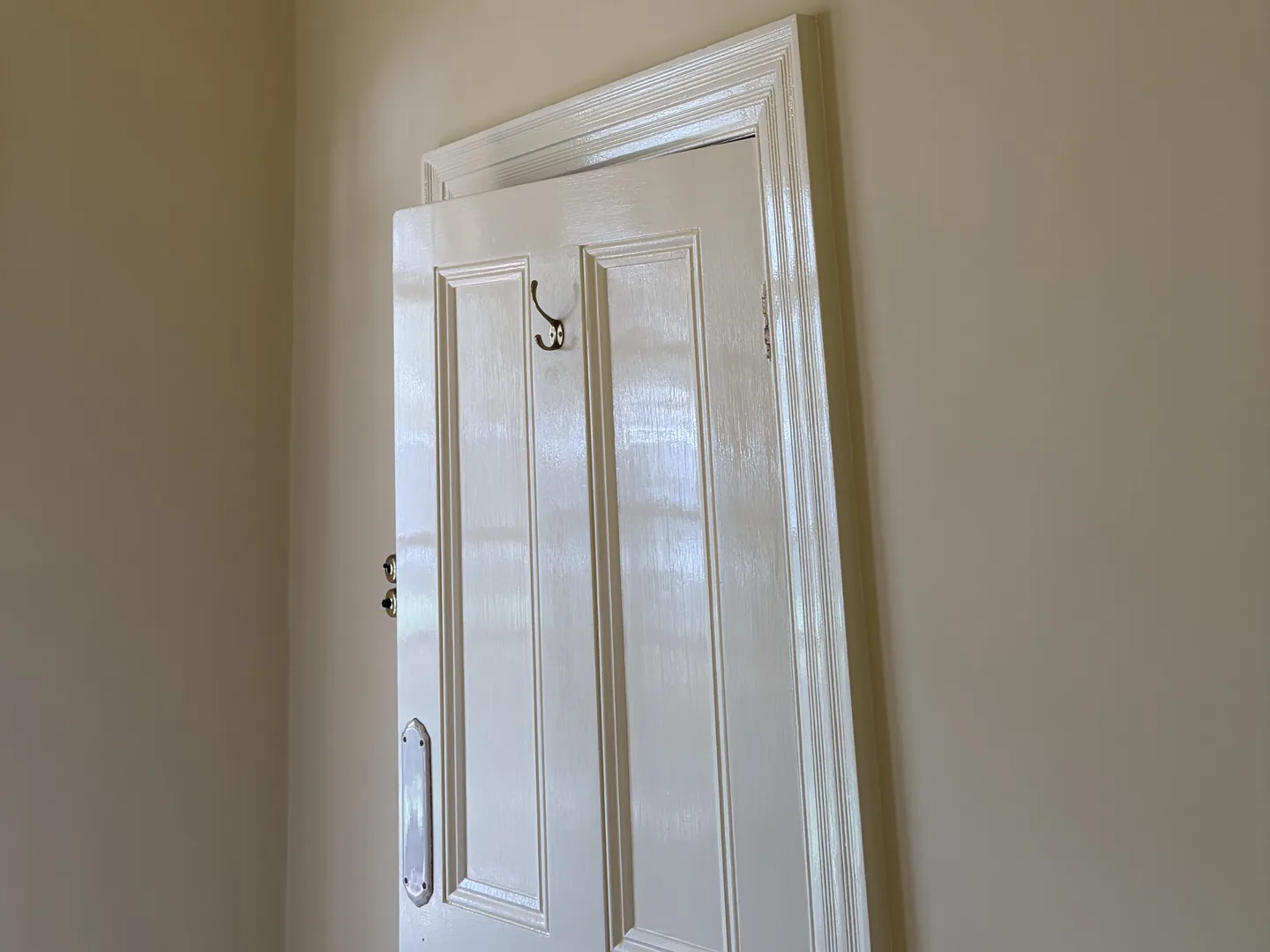 Panelled internal door and architrave freshly painted in white gloss enamel, door painting across Braybrook and Melbourne