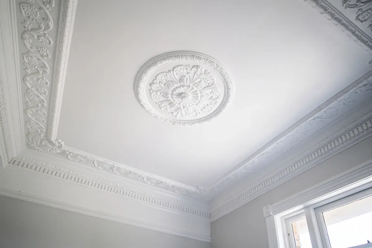 An ornate painted ceiling rose and cornice in a Melbourne period home