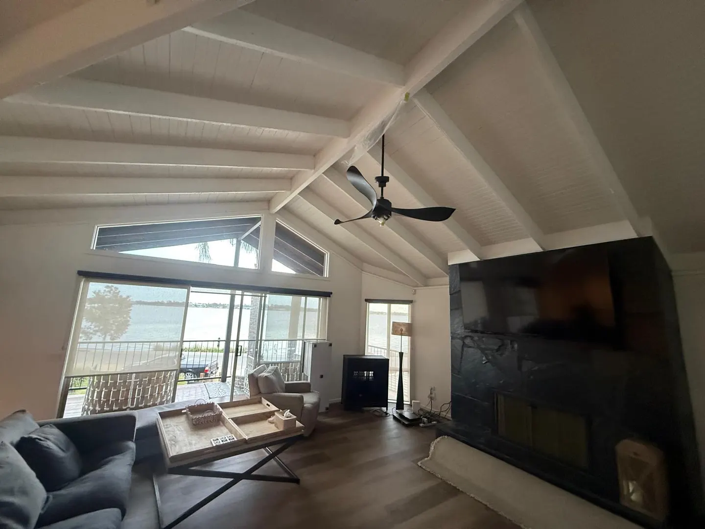 Living room ceiling beams and lining boards freshly painted by interior painters