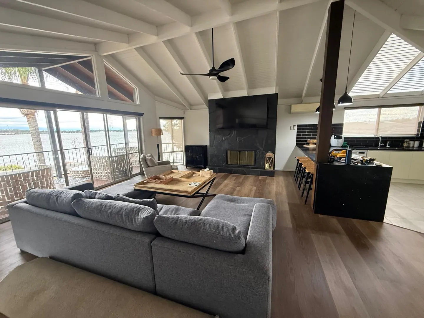 Open-plan living room with ceiling, exposed beams and walls repainted by Modernize Solutions interior painters
