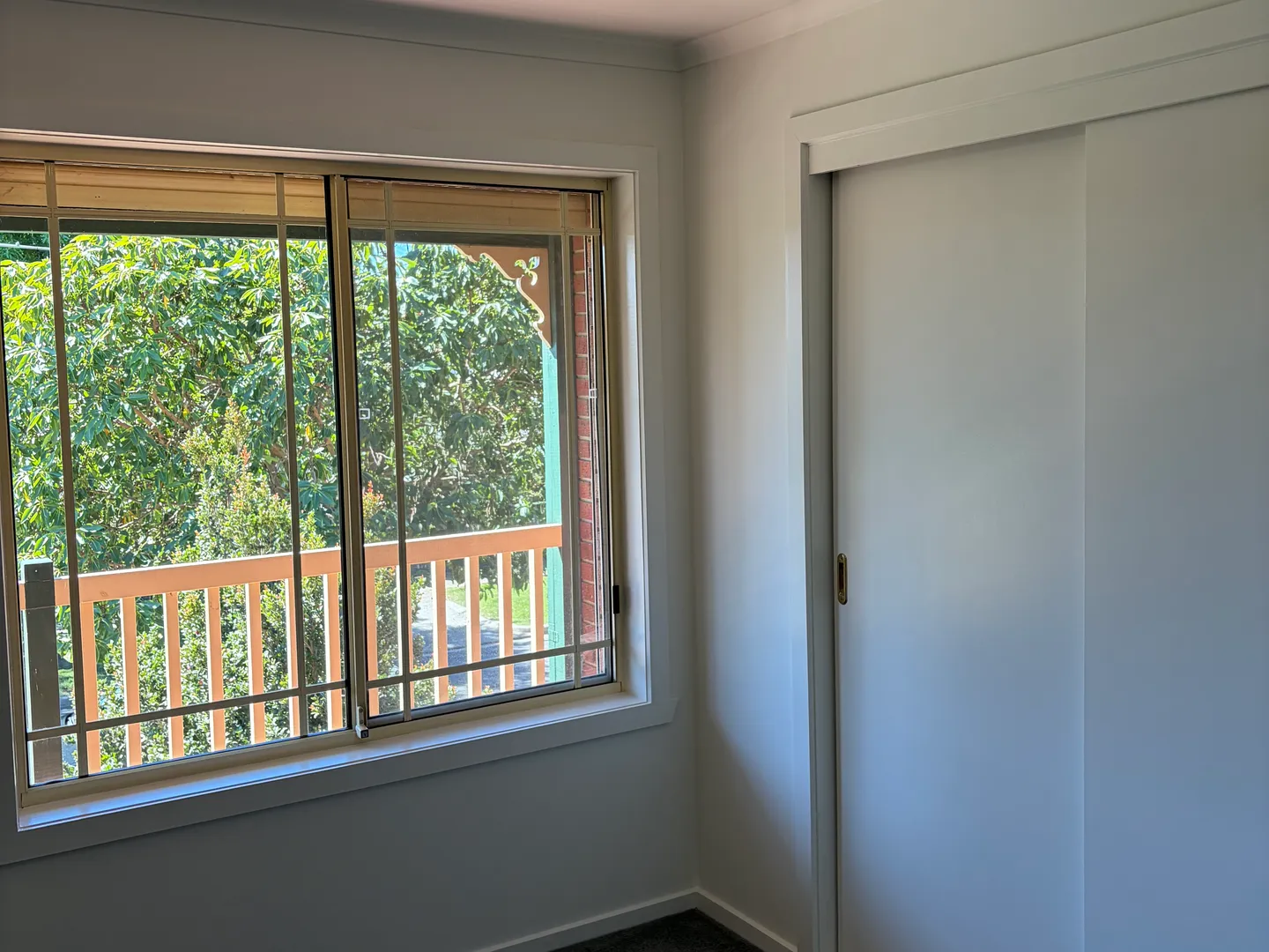 Bedroom window frame and sliding robe doors in white enamel, painted by Modernize Solutions in Maidstone