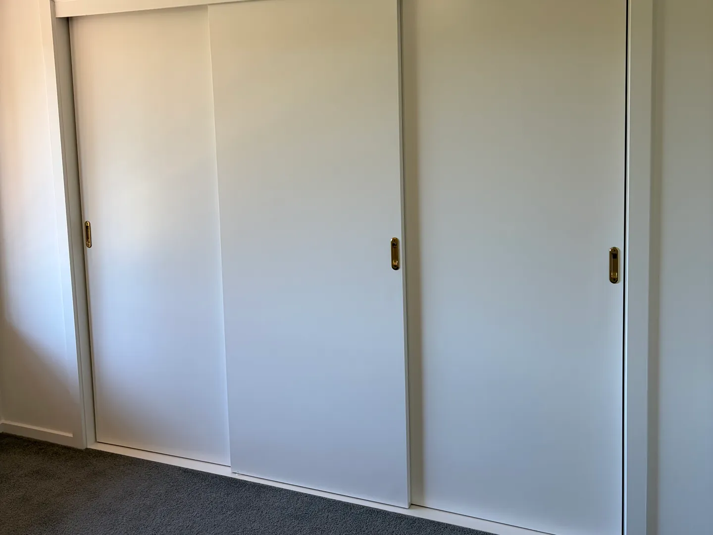 Sliding robe doors finished in white enamel in a two-storey Maidstone townhouse, painted by Modernize Solutions