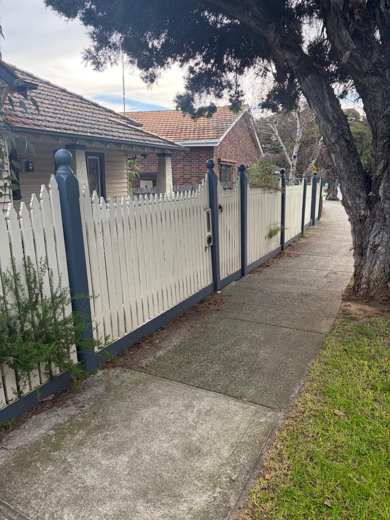 Weathered picket fence and gate before painting at a Melbourne weatherboard home