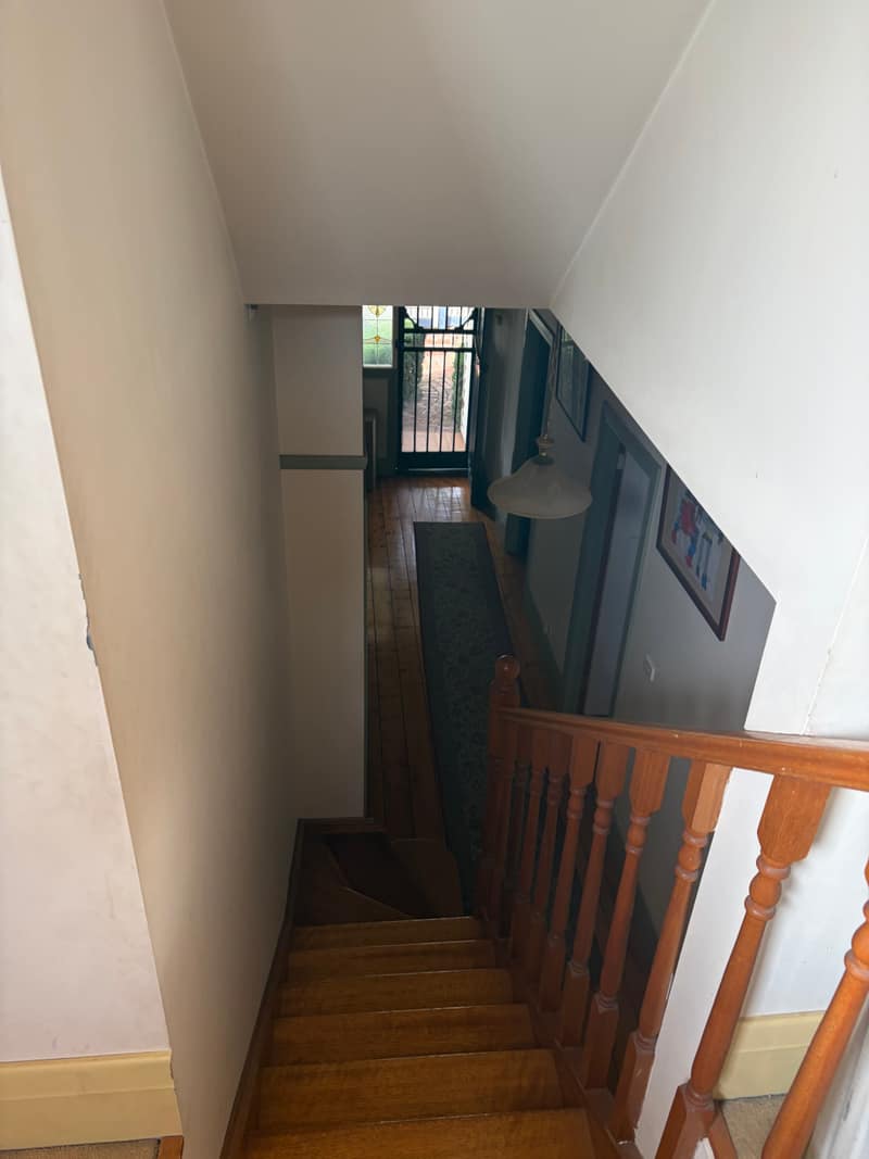 Timber stairs and entry hall before interior painting