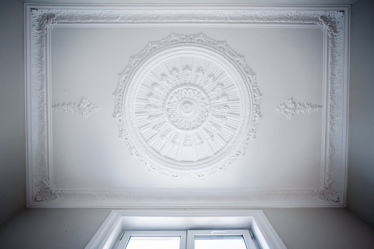 Freshly painted white ceiling with ornate ceiling rose and heritage cornice detail in a Footscray period home