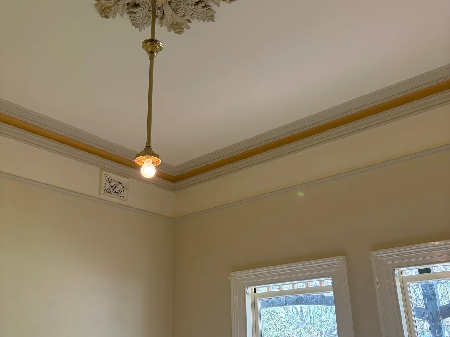 Period room with freshly painted white double hung window frames, cornices and picture rail, window frame painting across Braybrook and Melbourne's west